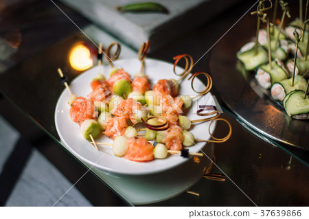 Canapes of salmon, lined on a white plate. Canapes of salmon, lined on a white plate. 37639866