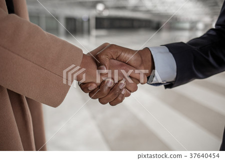 Man and woman are shaking hands 37640454