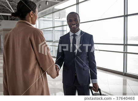 Man and woman are shaking hands with smile Man and woman are shaking hands with smile 37640468