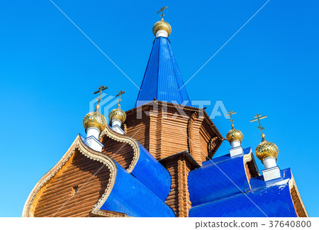 Traditional wooden orthodox church with domes Traditional wooden orthodox church with domes 37640800