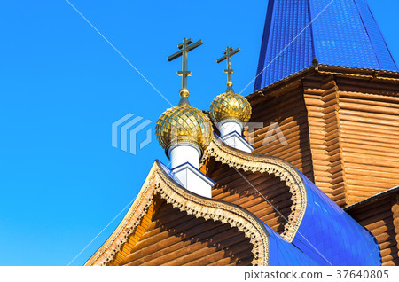 Golden domes with crosses on wooden church Golden domes with crosses on wooden church 37640805
