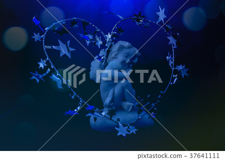 Figurine of an angel on a blue background. Figurine of an angel on a blue background. 37641111