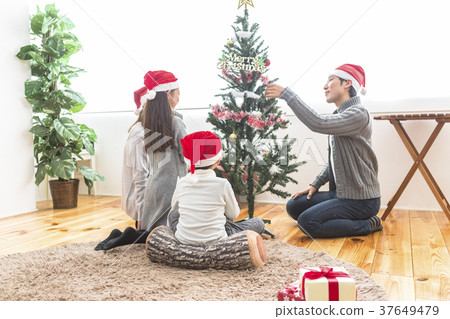 Family decorating the tree Family decorating the tree 37649479