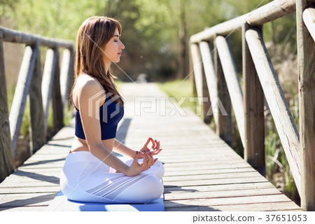 Young beautiful woman doing yoga in nature Young beautiful woman doing yoga in nature 37651053