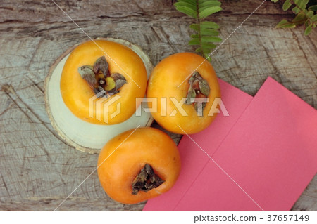 persimmons fruit with red envelopes 37657149