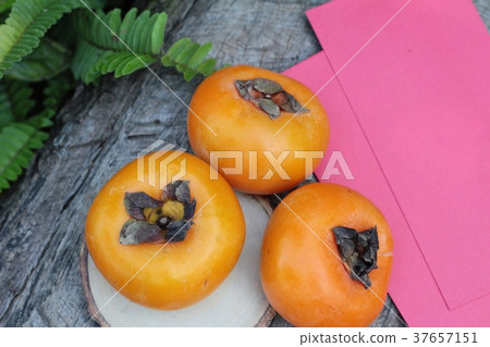 persimmons fruit with red envelopes 37657151