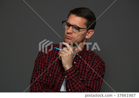 Attractive man posing on dark background Attractive man posing on dark background 37661987