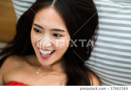 Woman lying on bed Woman lying on bed 37662369