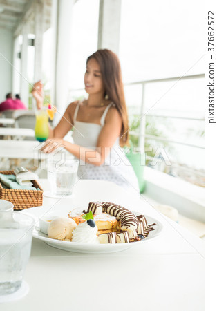 A woman at a cafe A woman at a cafe 37662572
