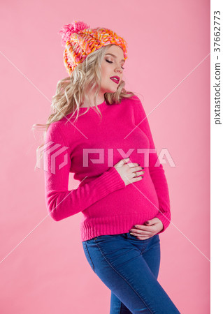 Portrait of blonde pregnant woman is wearing warm 37662773