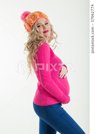 Blonde happy pregnant woman is wearing warm winter Blonde happy pregnant woman is wearing warm winter 37662774