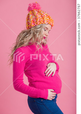 Blonde happy pregnant woman is wearing warm winter Blonde happy pregnant woman is wearing warm winter 37662787