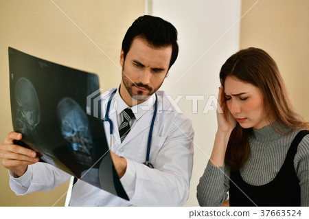 Health Concepts. Doctor and patient viewing x-ray film. The doct 37663524