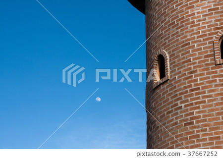 red brick block round tower with two round windows 37667252