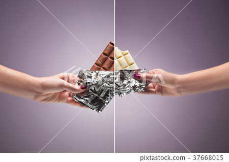Hands of a woman holding a tile of chocolate 37668015