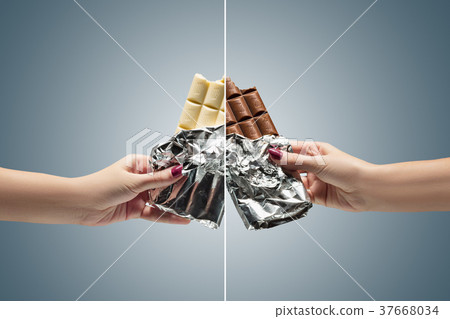 Hands of a woman holding a tile of chocolate 37668034