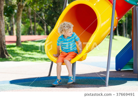 Kids on playground. Children play in summer park. 37669491