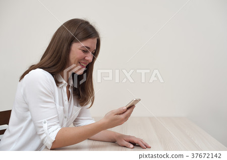 Beautiful positive young woman with smartphone 37672142