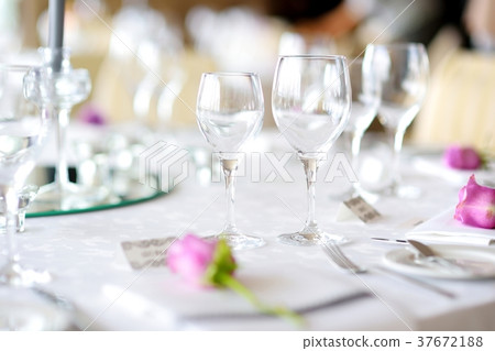 Beautiful table setting with crockery and flowers  37672188