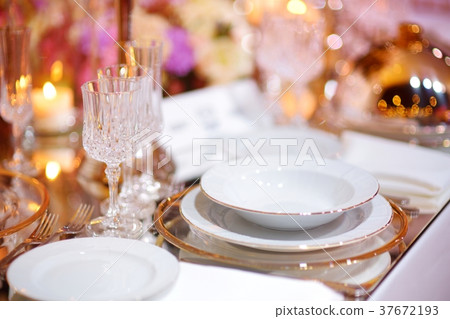 Beautiful table setting with crockery and flowers 37672193