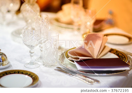 Beautiful table setting with crockery and flowers 37672195