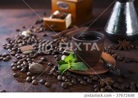 Coffee in cup and mint leaves on dark stone table. 37672686