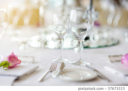 Beautiful table setting with crockery and flowers 37673315