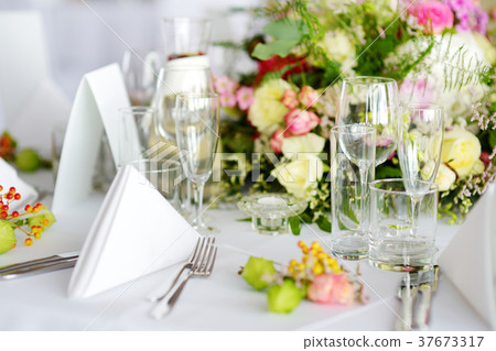 Beautiful table setting with crockery and flowers 37673317