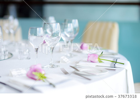 Beautiful table setting with crockery and flowers 37673318