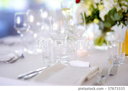 Beautiful table setting with crockery and flowers 37673335