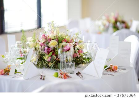 Beautiful table setting with crockery and flowers Beautiful table setting with crockery and flowers 37673364