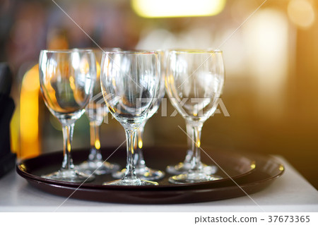 Lots of wine glasses during some festive event 37673365