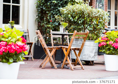 Outdoor cafe on a street of typical greek Outdoor cafe on a street of typical greek 37675171