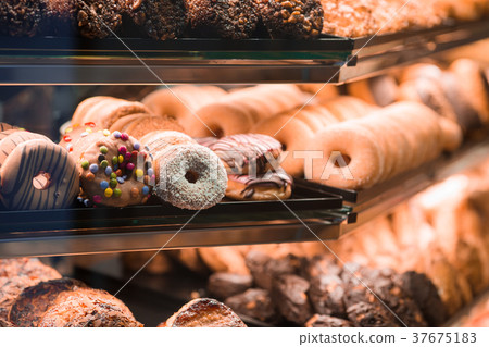 Different sorts of donats on breakfast in cafe Different sorts of donats on breakfast in cafe 37675183