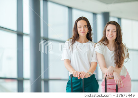 Young tourist women with baggage in international Young tourist women with baggage in international 37675449