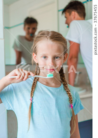 Little beautiful girl with white teeth and her Little beautiful girl with white teeth and her 37675455