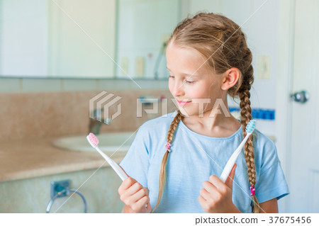 Little beautiful girl with white teeth and her 37675456