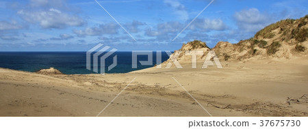 Sand dune and blue sea.  37675730
