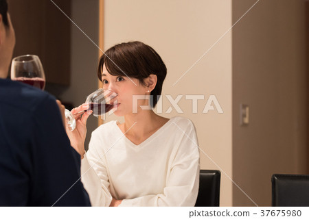 Middle couple drinking wine 37675980
