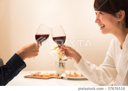 Middle couple drinking wine 37676510