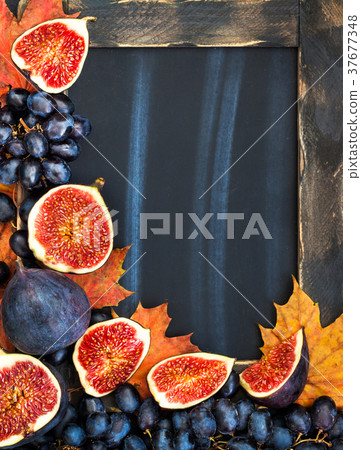 Autumn frame with chalk board, leaves, figs  37677348