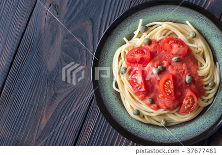 Pasta with tomato sauce and capers on the plate 37677481