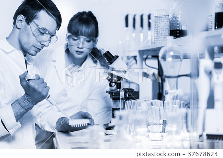 Health care professionals microscoping in 37678623