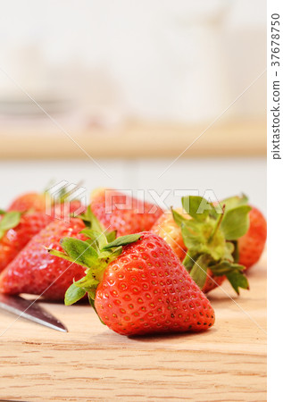 Fresh strawberries on a wooden cutting board 37678750