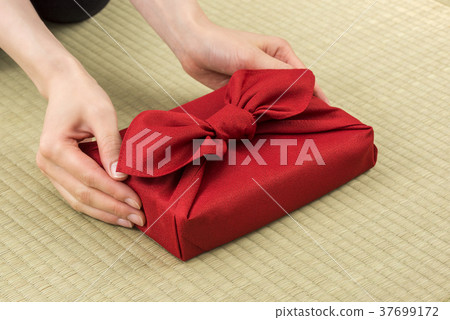 Hand of woman handing hand souvenir of bath cloth Hand of woman handing hand souvenir of bath cloth 37699172