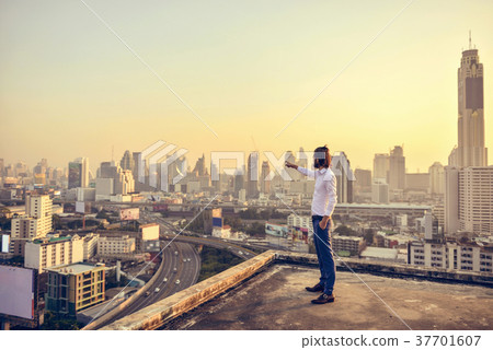 Western businessman looking at Bangkok City at sunset 37701607