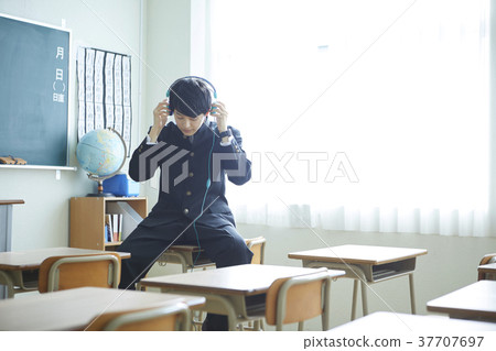 Male student playing headphones 37707697