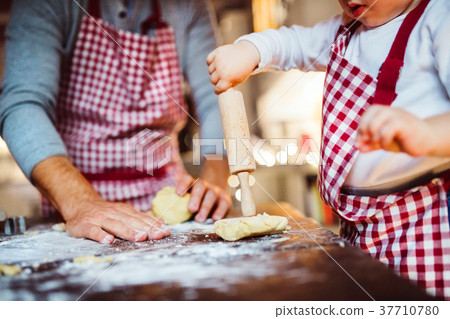 Young family making cookies at home. 37710780