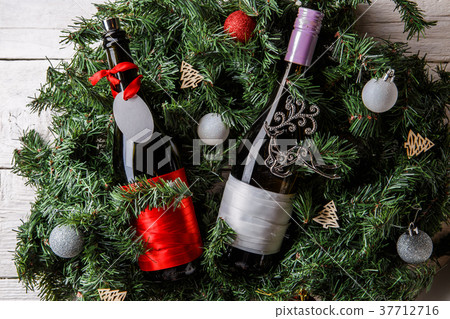 Photo of spruce branches with two bottles of wine 37712716