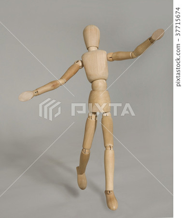 puppet in motion on grey background 37715674